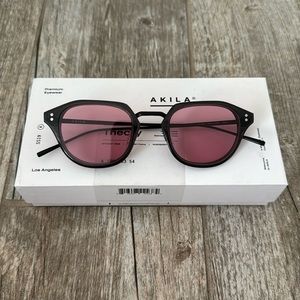 Brand new akila sunglasses. Dark grey frames with raspberry lenses.